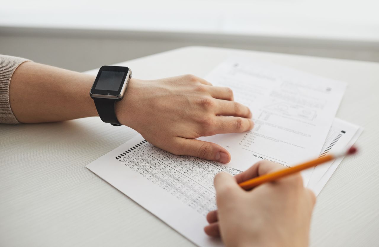 Home Student completing a multiple-choice exam with a pencil, close-up view.